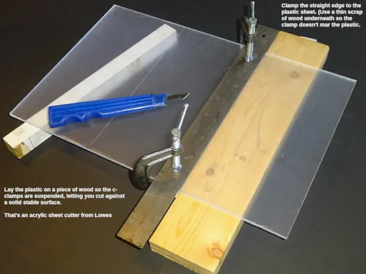 The plastic sheet clamped to straight-edge for cutting